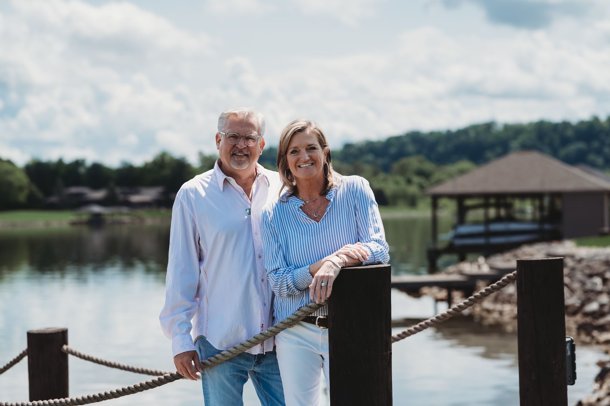 Steve and Melissa Fultz standing together on a dock by the water